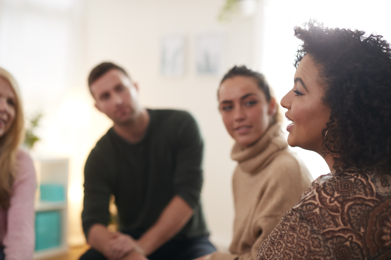 A woman speaks to a small group